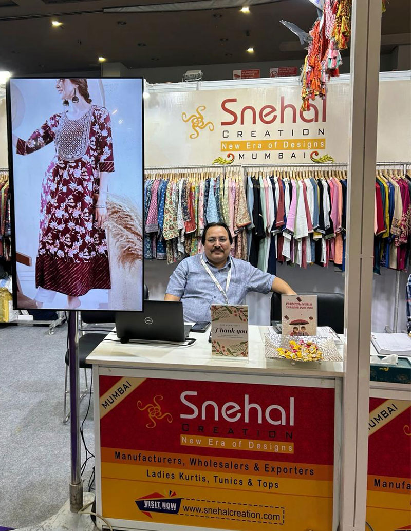 Snehal Creation founder at the Bharat Tex 2025 booth, New Delhi, showcasing ladies kurtis